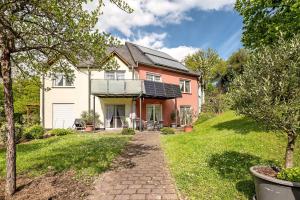 a house with solar panels on the roof at Gästehaus Mühlenhof - Dornfelder in Maring-Noviand