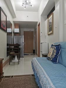 a bedroom with a blue bed and a dining room at Shore 3 mall of Asia condotel in Manila