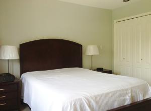 a bedroom with a large white bed with two lamps at Harmony House in Richmond