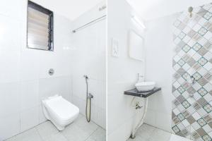 a white bathroom with a toilet and a sink at FabHotel The Horizon I in Lonavala