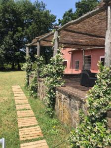 a pink house with a brick walkway in front of it at Colle Rampo in Colleferro