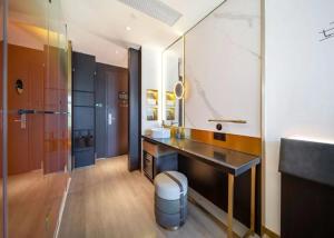 a bathroom with a sink and a mirror at CitiGO Hotel Beijing ABP in Beijing