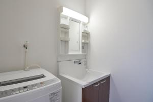 Una pequeña cocina blanca con fregadero y estufa. en 08 Resort Club -Theater-, en Fujikawaguchiko 34 fotos más