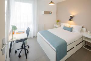 a bedroom with a bed and a desk and a bed at All Suites Appart Hôtel - Le Havre Centre - Les docks in Le Havre