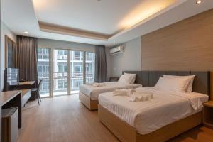 Postel nebo postele na pokoji v ubytování Tisha Hotel