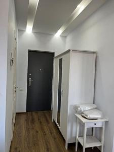 a room with a hallway with a table and a door at 3 minutes walk from the sea in Batumi