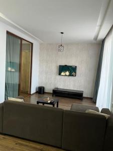 a living room with a couch and a table at 3 minutes walk from the sea in Batumi