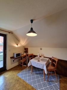 a living room with a table and chairs and a microwave at Vila Nana Bled Apartments & Rooms in Bled