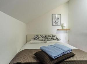 a bedroom with a bed with two towels on it at Villa Rubcic in Rakovica +26 photos