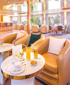 a restaurant with a couch and a table and chairs at Bateau Botticelli by CroisiEurope in Paris