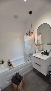 a white bathroom with a sink and a mirror at Moon Studio in Popeşti-Leordeni +25 photos