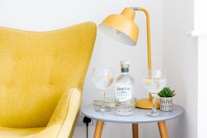a table with a bottle of wine and two glasses at The Nook - Self Serviced Accommodation in St Ives