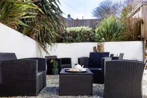 a patio with wicker chairs and a table at The Nook - Self Serviced Accommodation in St Ives