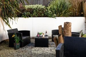 a patio with chairs and a table in a garden at The Nook - Self Serviced Accommodation in St Ives