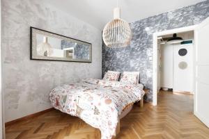 a bedroom with a bed and a mirror at De Lux apartment! Great location! Bohemic getaway! in Helsinki