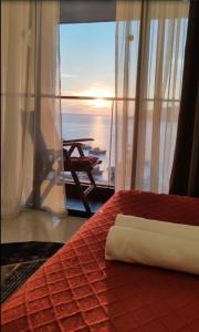 a bedroom with a bed with a view of the ocean at Seaview Bliss Studio By Tropical Elegance in Kota Kinabalu