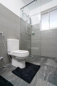 a bathroom with a toilet and a glass shower at Regent Heights in Kandy