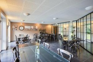 a restaurant with tables and chairs in a room at Danhostel Esbjerg in Esbjerg