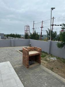a brick fireplace sitting on top of a patio at Grandview adventure and guesthouse in East London