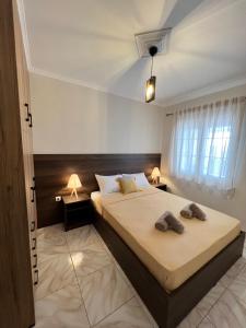 a bedroom with a bed with two towels on it at PanDora Home in Moúdhros