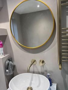 een badkamer met een witte wastafel en een spiegel bij Stunning 3 bedroom house sleeps up to 6 in Norwood