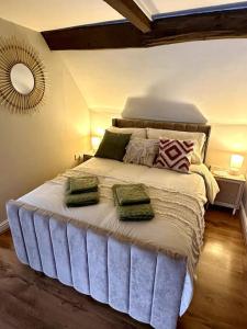 a bedroom with a large bed with two pillows on it at Countryside Loft in Bridgnorth in Bridgnorth