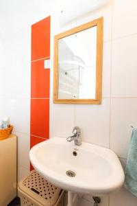 a bathroom with a white sink and a mirror at Apartment Sea Organ in Zadar