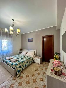 a bedroom with a large bed and a table at La Soffitta - Appartamenti in Villa in San Giorgio a Liri