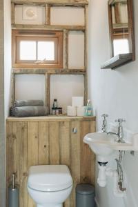 a bathroom with a toilet and a sink at 5 Henham Barns in Beccles