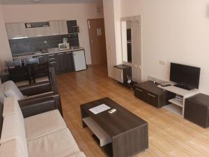 a living room with a couch and a table at Magic Dreams Apartments in Sveti Vlas