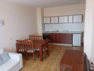 a kitchen and living room with a table and chairs at Magic Dreams Apartments in Sveti Vlas