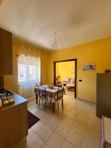 una cucina con tavolo e una sala da pranzo di La Soffitta - Appartamenti in Villa a San Giorgio a Liri