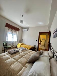 a bedroom with two beds and a mirror at La Soffitta - Appartamenti in Villa in San Giorgio a Liri