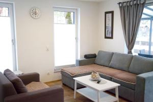 a living room with a couch and a table at Appartement HANNE in Saalfelden am Steinernen Meer