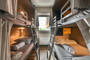 a group of bunk beds in a dorm room at Wombat's City Hostel Munich Werksviertel in Munich
