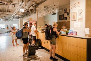 a group of people standing at the counter of a restaurant at Wombat's City Hostel Munich Werksviertel in Munich