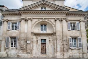 a large stone building with windows and a door at La Chapelle du Miracle in Avignon