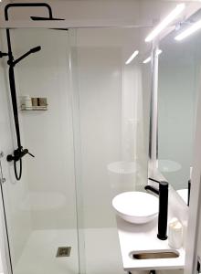 a white bathroom with a sink and a shower at Alojamiento Dream en Murcia centro in Murcia