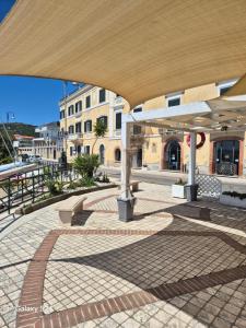 a pavilion with tables and benches on a city street at residence paradiso in Formia