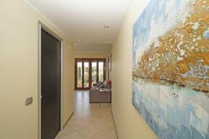 a hallway with a large painting on the wall at Apt Il Barcone - Gardagate in Sirmione