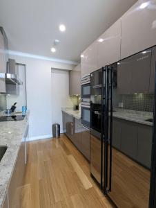 a kitchen with stainless steel appliances and wooden floors at Buddha Vista Luxury apartment in Ulaanbaatar