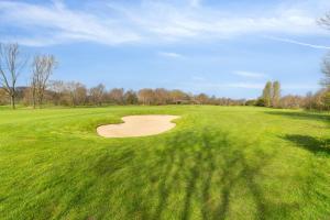a golf course with a hole in the grass at Come Stay 3BR - Havudsigt m.plads til 5 personer in Hørsholm +18 photos