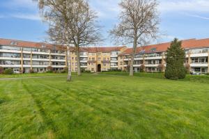 an empty field in front of an apartment building at Come Stay 3BR - Havudsigt m.plads til 5 personer in Hørsholm