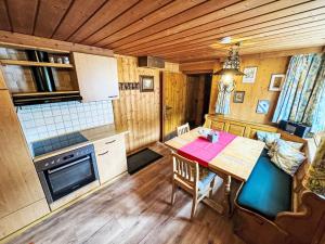 a kitchen with a wooden table and a dining room at Apartment Helmreich-3 by Interhome in Sankt Gallenkirch