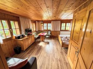 a living room with wooden walls and a wooden floor at Apartment Helmreich-1 by Interhome in Sankt Gallenkirch