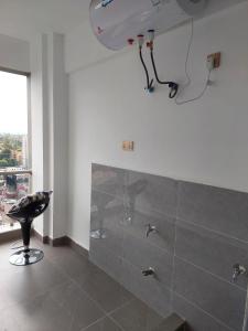 a bathroom with a shower and a stool in a room at Luxury Apartment Lavington in Mutomo