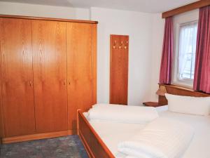 a bedroom with two beds and a cabinet at Holiday Home Subretta-5 by Interhome in Kappl +22 photos