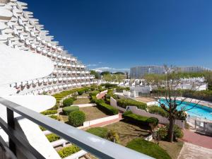 a view of a resort with chairs and a pool at Apartment Du Soleil-3 by Interhome in La Grande Motte