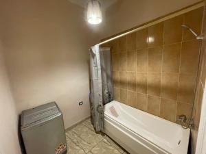a bathroom with a shower and a tub and a toilet at Alexander spot in Alexandria
