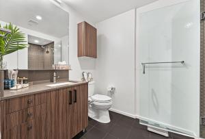 a bathroom with a toilet and a sink and a shower at Boston VIP Quarters by Orchard Group in Boston